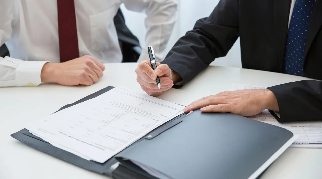 Hands signing document
